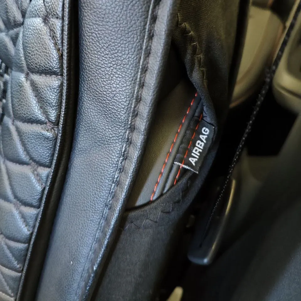 Pattern-cut seat cover that leaves the airbag zone intact and follows MG bolster geometry
